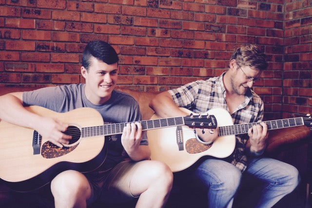 friends visiting guitar gallery, talking guitars and music