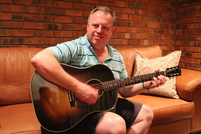Sitting with the Gibson J-45 guitar